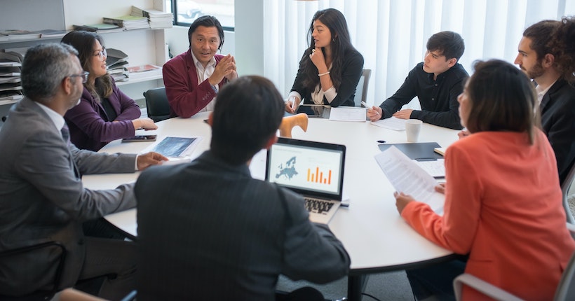 Leader coaching team member in focused one-on-one conversation demonstrating active listening and strategic questioning